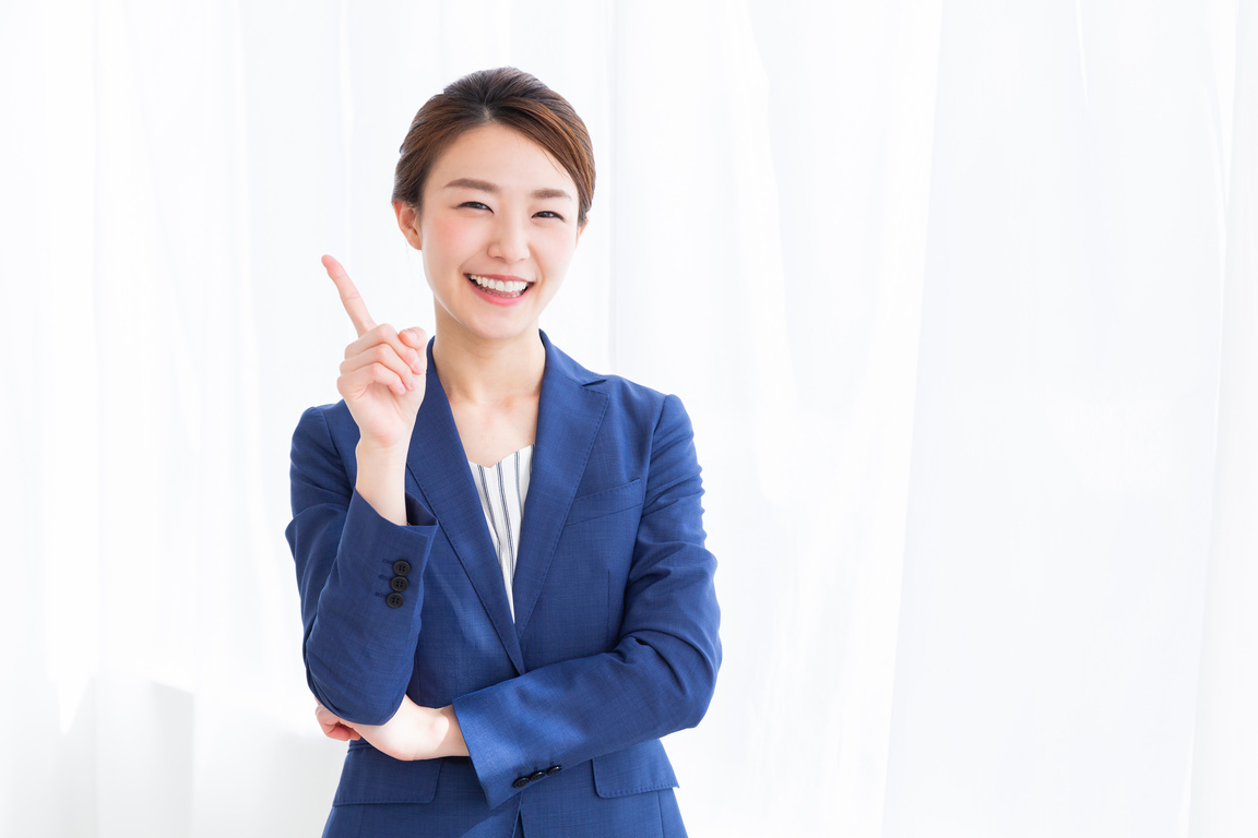 Portrait of a Woman in Businesswear Pointing to the Side 